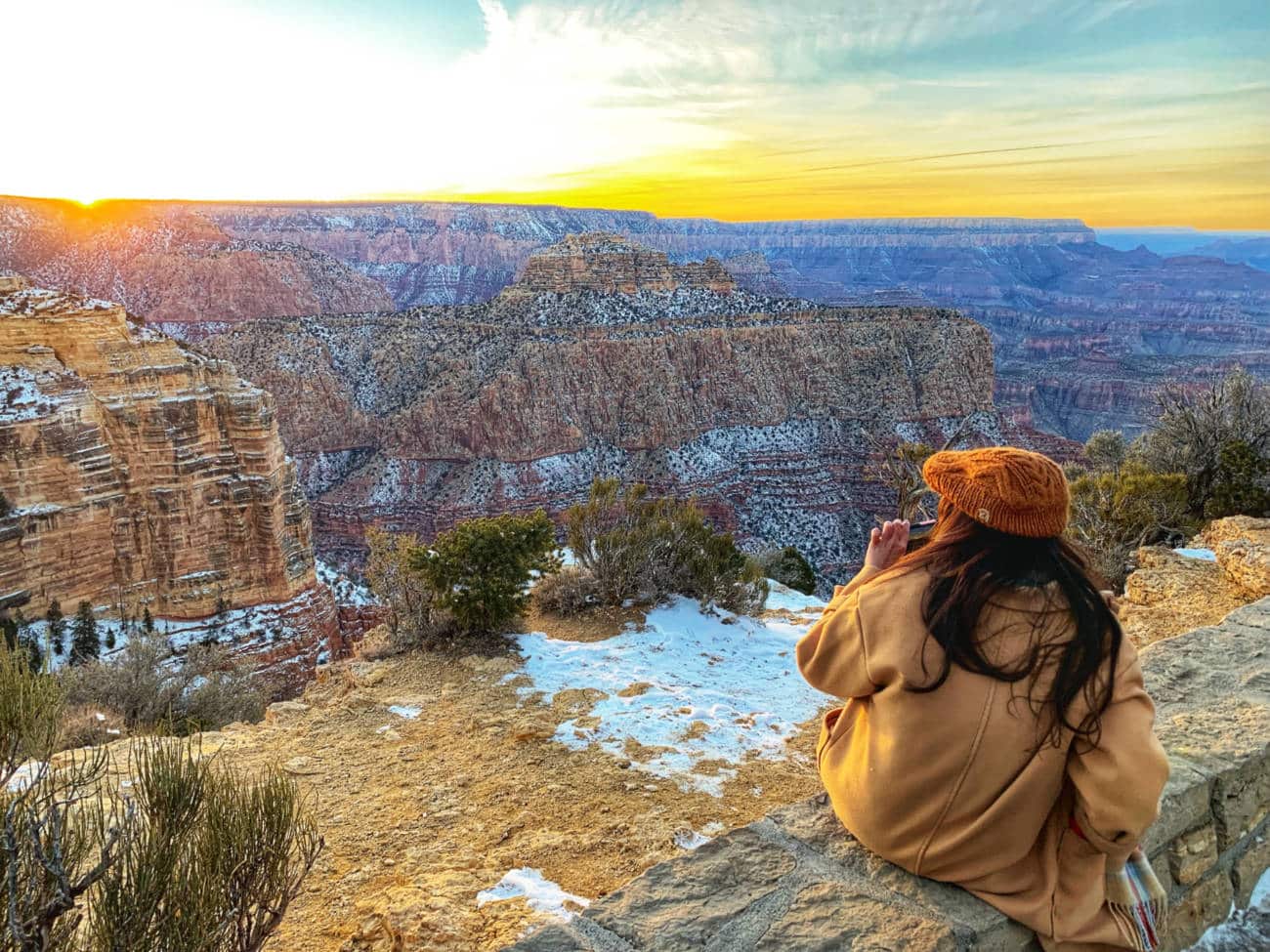 Girl looking at the Grand Canyon in winter