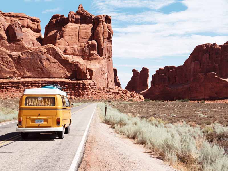 Taking a small shuttle from Las Vegas to the Grand Canyon along a desert road.