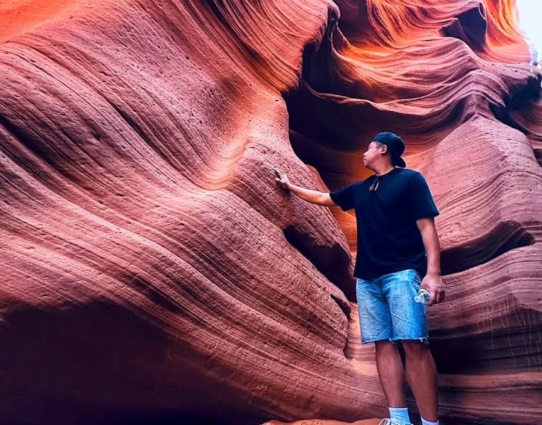 Tour Guest Feeling the Wall at Lower Antelope Canyon