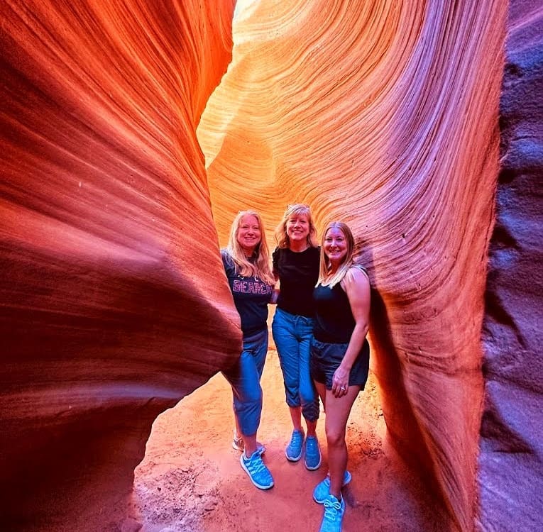 3 women posing inside Lower Antelope Canyon