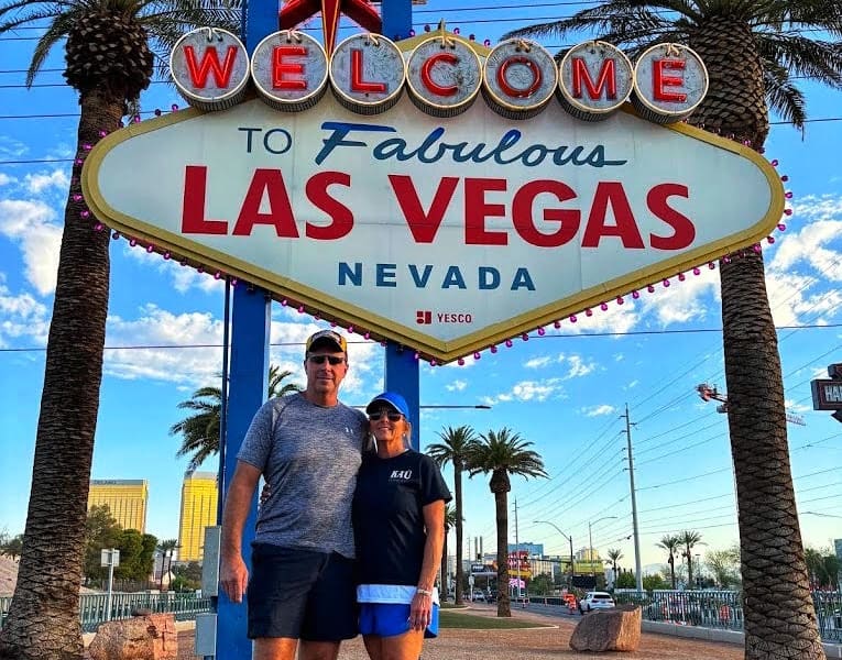 Couple posing in front of Welcome to Las Vegas sign